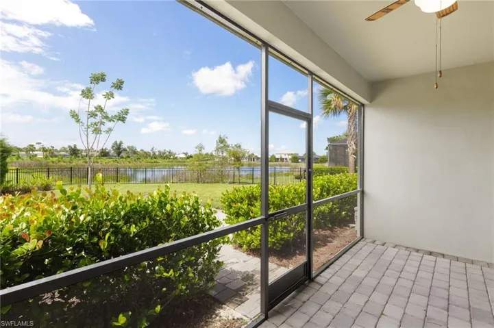 Unfurnished sunroom featuring a water view and ceiling fan