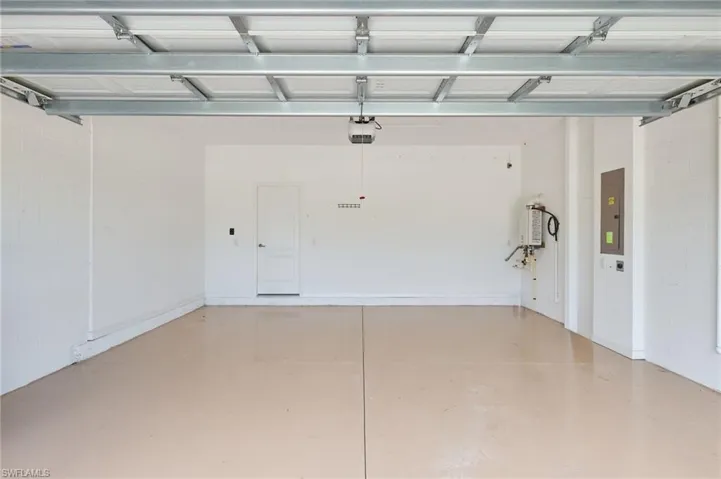 Garage with electric panel and a garage door opener