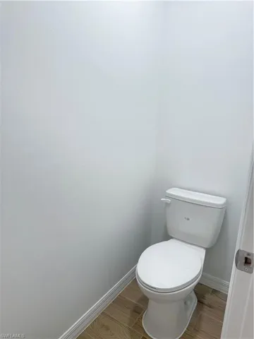 Bathroom with baseboards and wood tiled floors