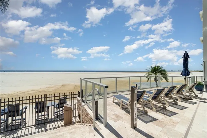 View of patio featuring view of water and beach