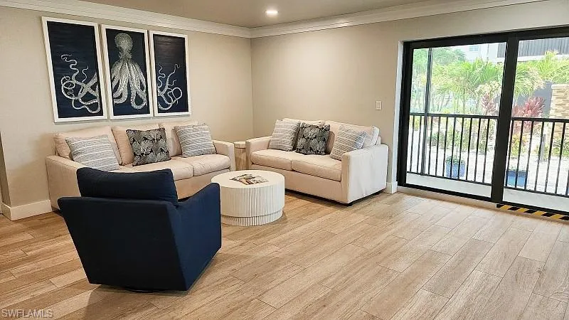 Community RM Living room featuring crown molding, light wood-style floors, and recessed lighting