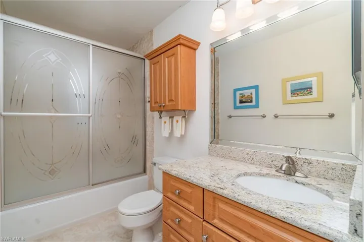 Guest bathroom with vanity, enclosed tub / shower combo and linen closet (not shown)