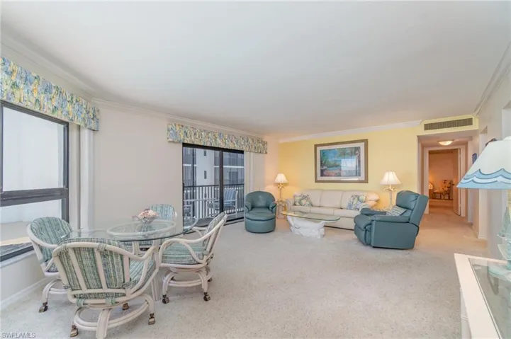 Large Living room featuring large picture window, ornamental molding, carpet floors, and plenty of natural light