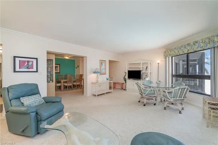 Carpeted living area with big picture window of Fort Myers Beach and Gulf