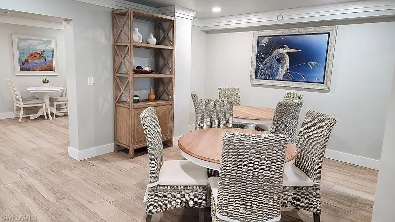 Community RM Dining area with light wood-type flooring and recessed lighting