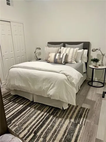 Bedroom featuring wood finished floors and a closet