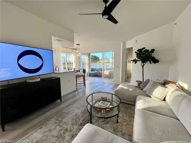 Living room with light wood-style floors and a ceiling fan