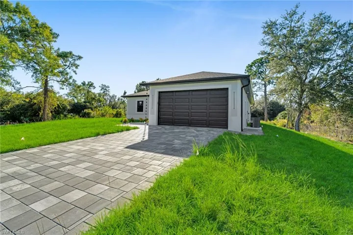 Garage featuring decorative driveway