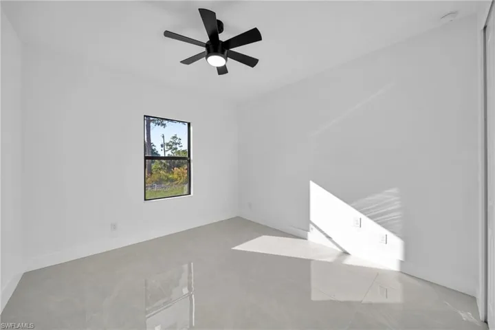 Empty room featuring a ceiling fan and concrete flooring