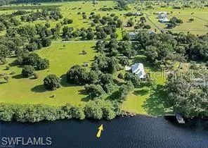 Birds eye view of property with a water view and a rural view
