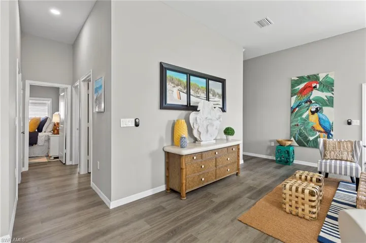 Sitting room featuring dark wood finished floors and baseboards