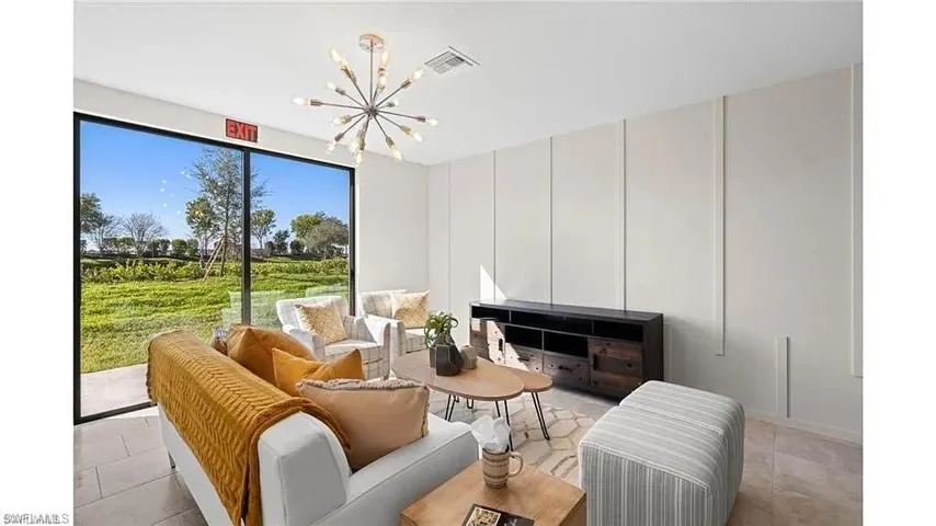 Living area with a chandelier and light tile patterned flooring