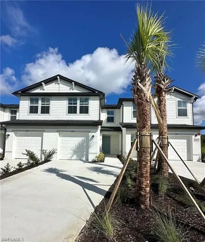 Traditional home with a garage and concrete driveway