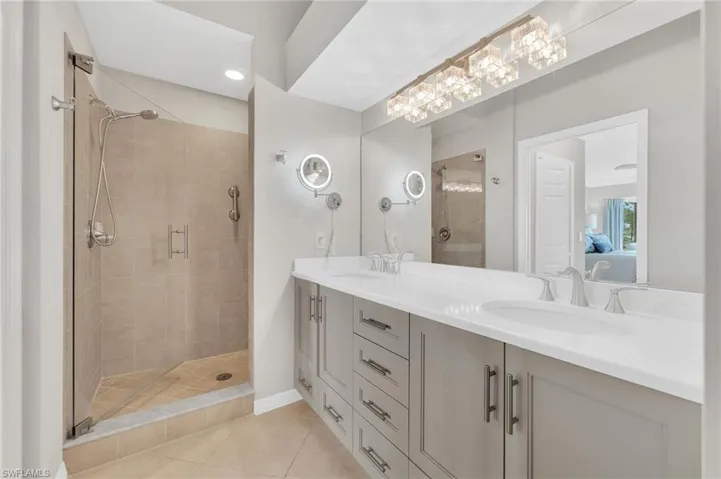 Gorgeous Primary Bath with frameless glass shower door, double sinks, new Lighting and updated vanity