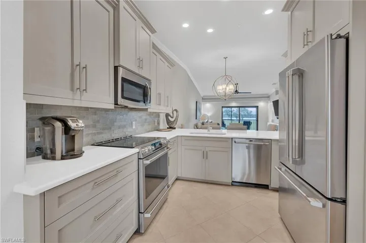 Newer upscale appliances, backsplash, Quartz counters, refaced cabinets  and  designer lighting