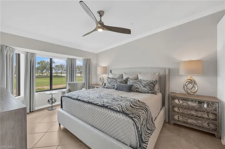 Primary bedroom with views of golf and lake.