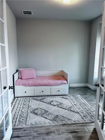 Sitting room with french doors and wood finished floors