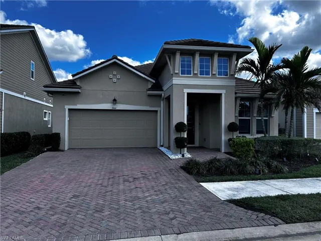 View of front of property featuring stucco siding, decorative driveway, an attached garage, and a tile roof
