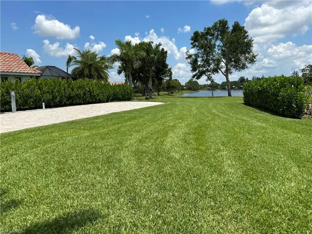View of green lawn featuring a water view