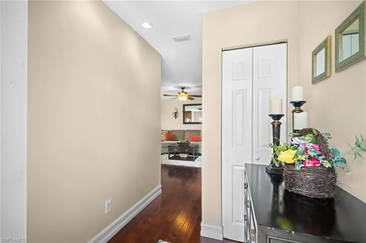 Corridor featuring dark wood-style floors and recessed lighting
