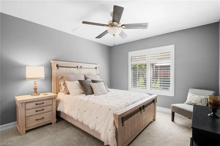 Bedroom with light carpet and ceiling fan