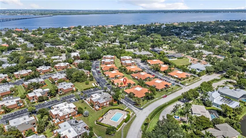 Aerial overview of property's location featuring a large body of water and nearby suburban area
