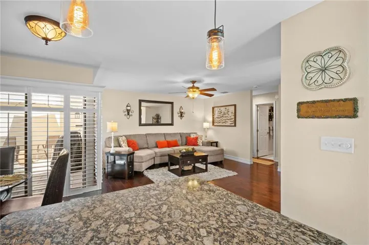 Living area featuring wood finished floors and ceiling fan