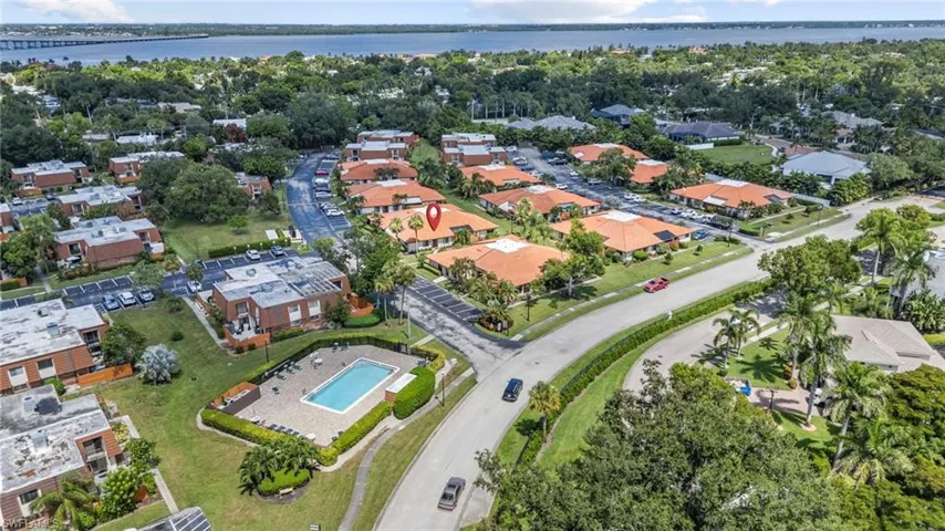 Aerial overview of property's location with a large body of water and nearby suburban area