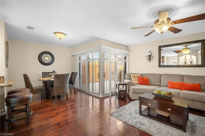 Living area featuring ceiling fan and wood finished floors