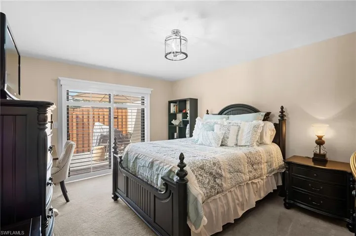 Bedroom with carpet floors and access to outside