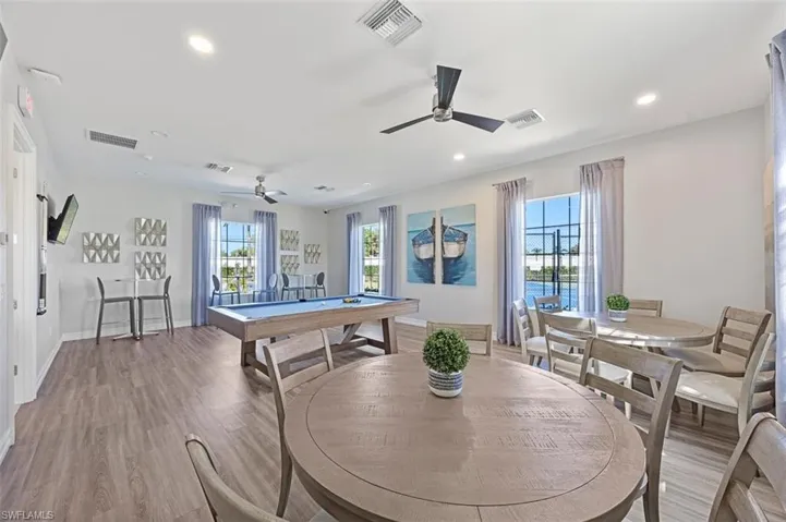 Recreation room with hardwood / wood-style flooring, ceiling fan, and pool table