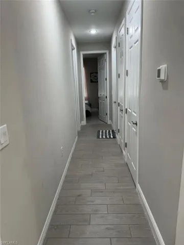 Hall with light hardwood / wood-style flooring