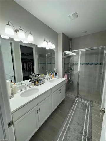 Bathroom featuring vanity and a shower with shower door