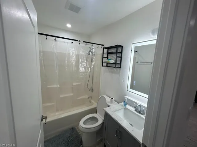 Full bath featuring shower / bath combination and vanity