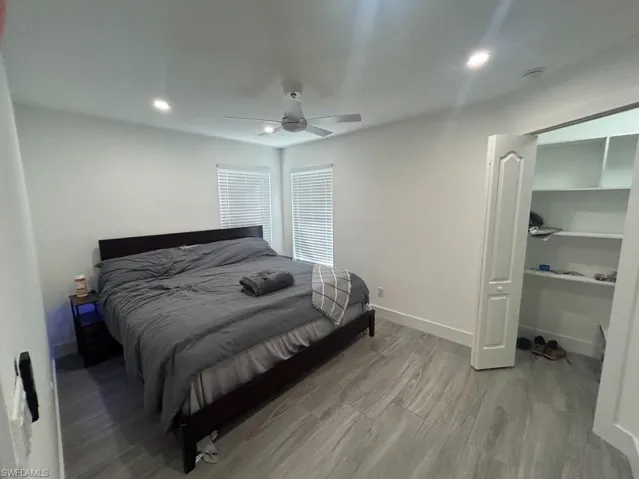 Bedroom with light wood-style floors, recessed lighting, and a ceiling fan
