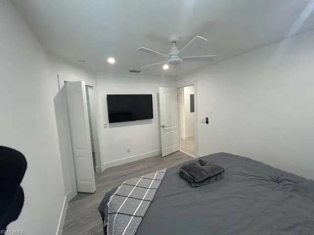 Bedroom with ceiling fan, light wood-style floors, and recessed lighting