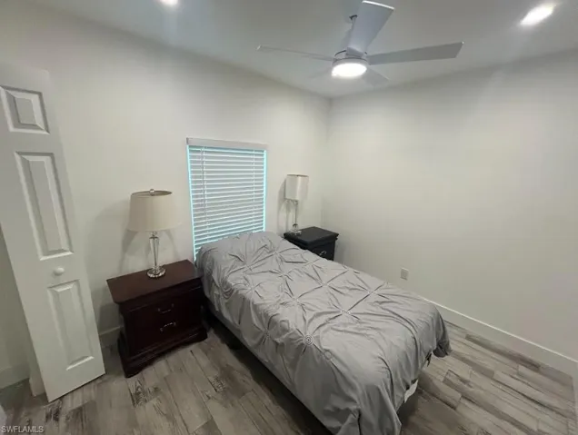 Bedroom featuring light wood-style flooring, a ceiling fan, and recessed lighting