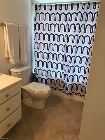 Bathroom with vanity, toilet, and tile floors