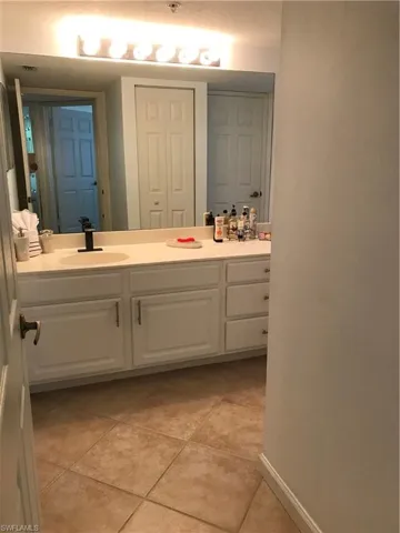 Bathroom featuring tile floors and vanity