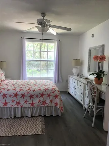 Bedroom featuring ceiling fan and dark hardwood / wood-style floors