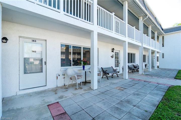 Open entry porch features seating for sharing time with neighbors.