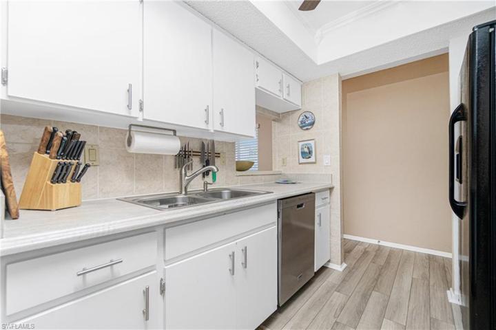 Ful tile backsplash extends up wall around pass-thru