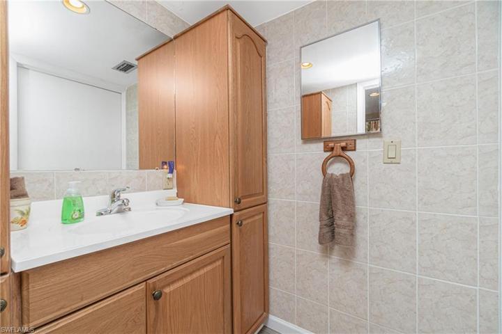 Hall bath features tiled walls.