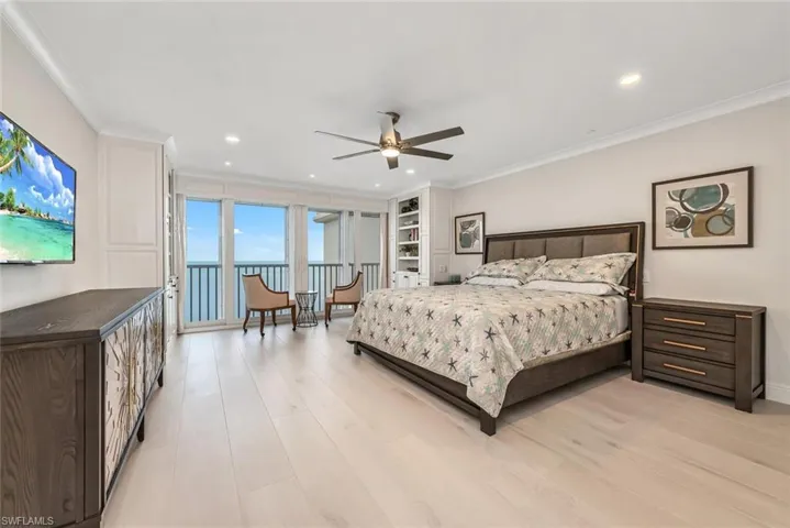Bedroom with recessed lighting, light wood-style floors, access to exterior, and ornamental molding