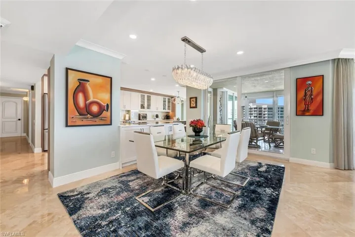 Dining space featuring baseboards, crown molding, a chandelier, and recessed lighting
