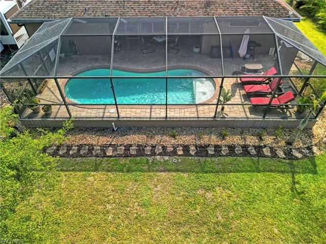 The property features a screened-in pool area with a saltwater pool and a paver patio
