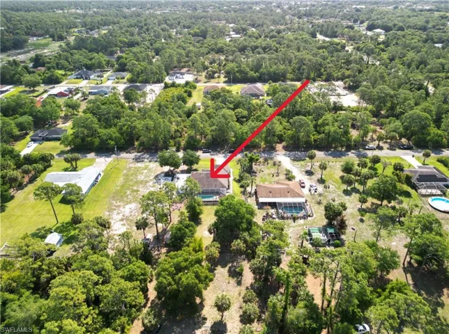 Aerial view of the property and its surrounding area from the backyard