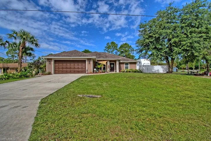 The property features an irrigation system, fenced yard and lush landscaping