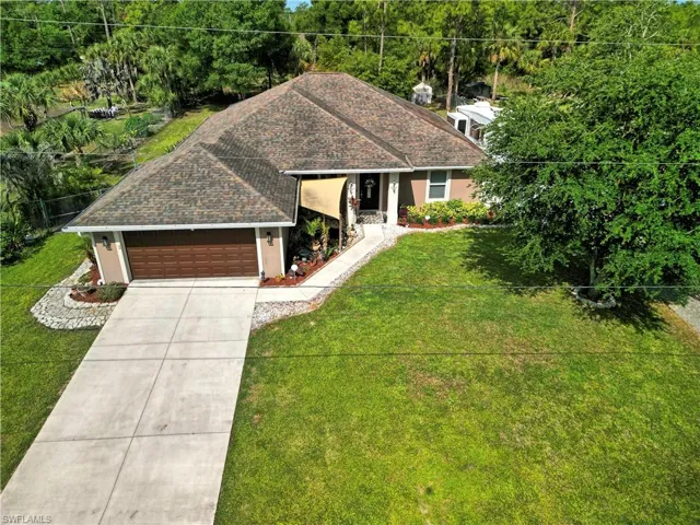 The property features a well-maintained lawn, fenced back yard, RV hook-up, EV charging station
