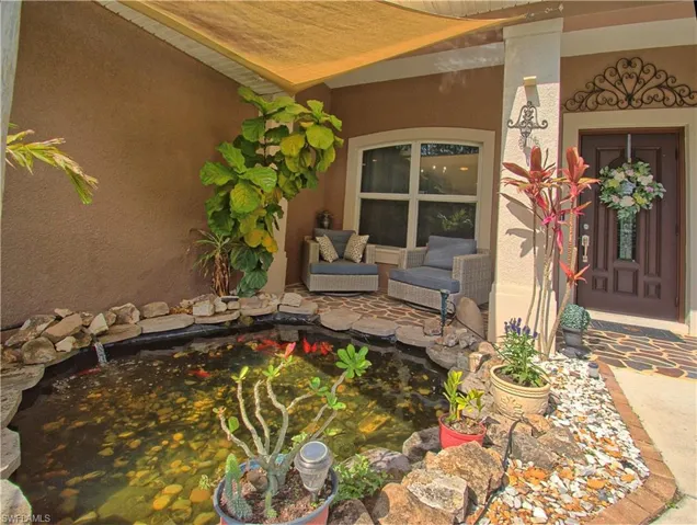 Relax on your front porch and enjoy the koi pond